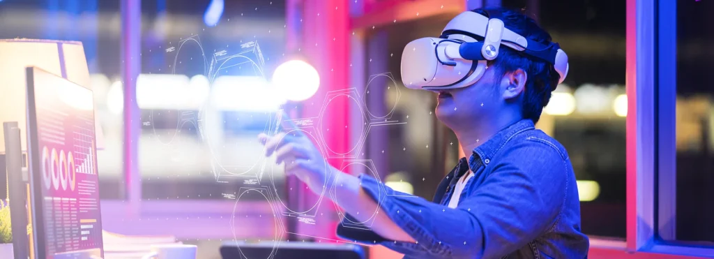 Person wearing a VR headset reaches toward floating holographic UI in a high-tech setting—blue and pink lighting in the background.